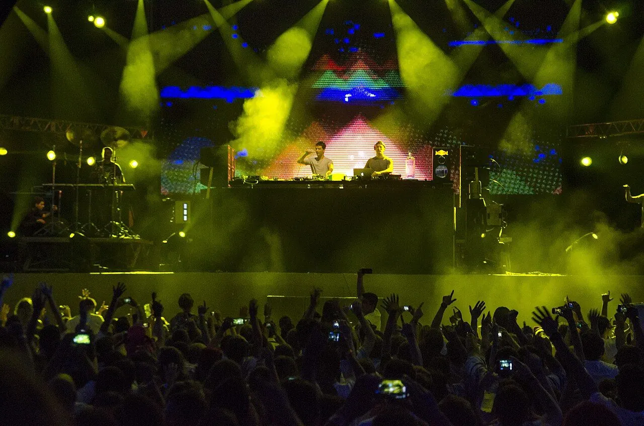 Crowd dancing in front of a festival dance stage