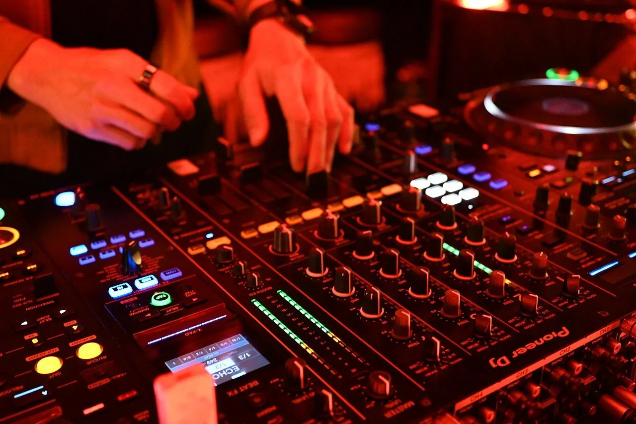 Beginner DJ mixing on a controller with headphones